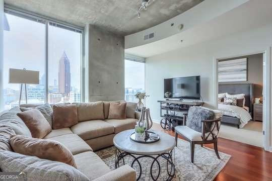 living room with floor to ceiling windows, plenty of natural light, and hardwood / wood-style floors