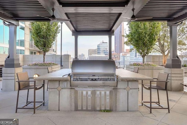 view of patio featuring a bar, area for grilling, and grilling area