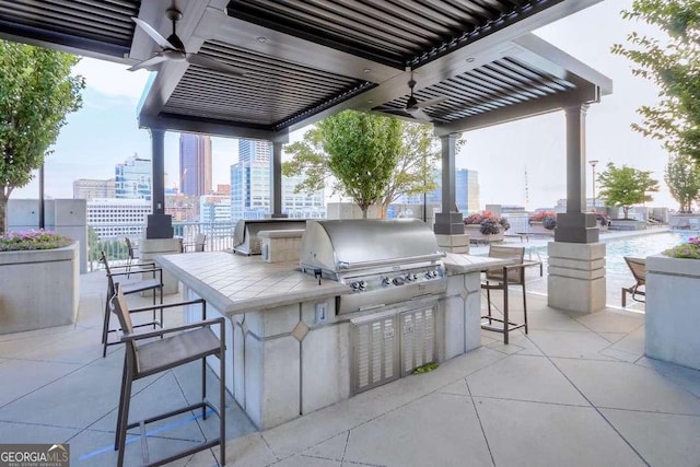 view of patio featuring area for grilling, a bar, and grilling area