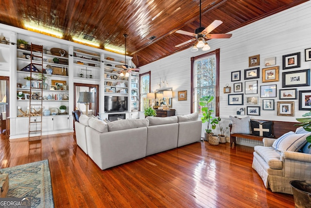 living room with dark hardwood / wood-style flooring, vaulted ceiling, wooden walls, built in features, and wooden ceiling