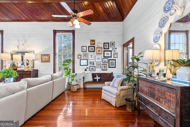 living room featuring hardwood / wood-style flooring, ceiling fan, wooden ceiling, and wooden walls