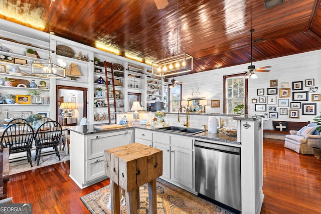 kitchen with white cabinetry, sink, ceiling fan, stainless steel dishwasher, and dark stone countertops