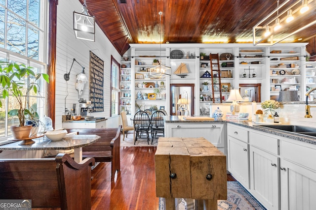 kitchen featuring lofted ceiling, white cabinets, sink, dark hardwood / wood-style floors, and wood ceiling