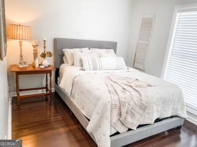 bedroom featuring dark hardwood / wood-style flooring