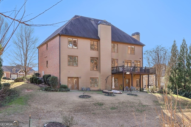 back of house featuring a patio area and a deck