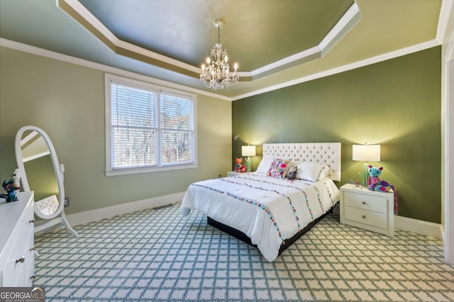 carpeted bedroom with a tray ceiling, ornamental molding, and a chandelier