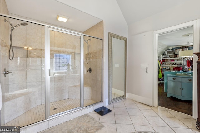 bathroom with vaulted ceiling, tile patterned floors, and walk in shower