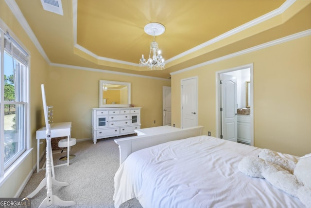 bedroom with a tray ceiling, ornamental molding, a chandelier, and carpet flooring