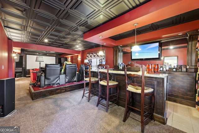 bar with light tile patterned floors, light stone counters, and decorative light fixtures