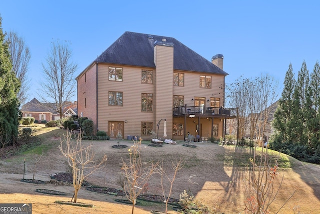 back of house featuring a deck