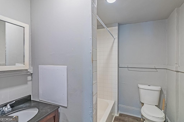 full bathroom featuring toilet, tiled shower / bath combo, and vanity