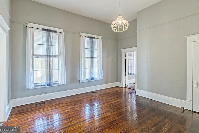 unfurnished dining area featuring dark wood-type flooring