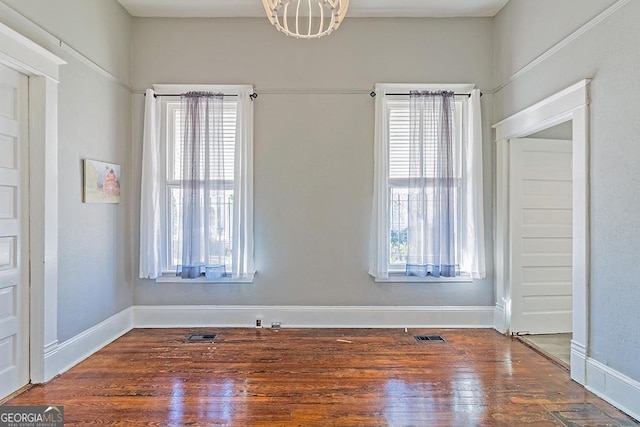 unfurnished room with hardwood / wood-style floors