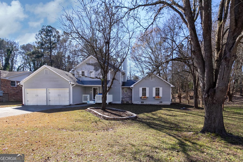 front of property with a front yard and a garage