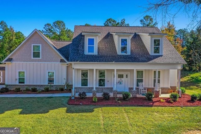 view of front of home with a front yard and covered porch