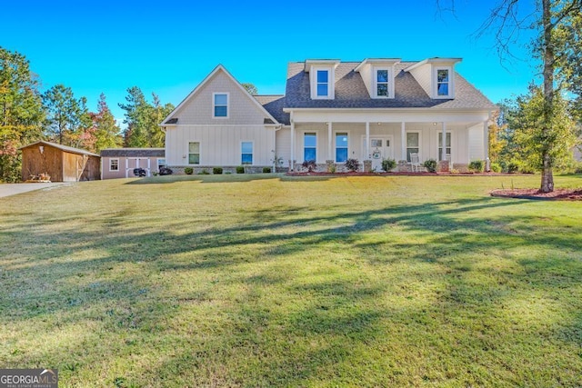 new england style home featuring a shed and a front lawn