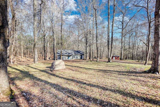 view of yard with a wooded view