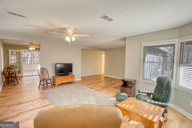 living room featuring light wood-type flooring and visible vents