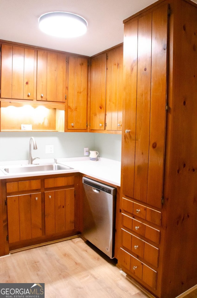 kitchen featuring dishwasher, light hardwood / wood-style flooring, and sink