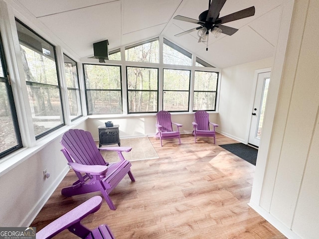 sunroom / solarium with ceiling fan, plenty of natural light, and lofted ceiling