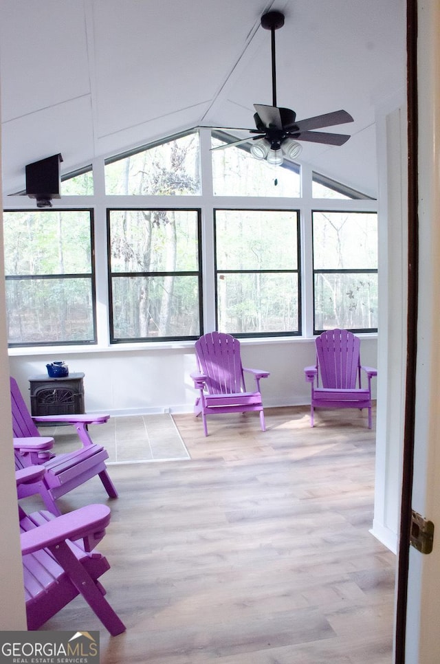 sunroom / solarium with ceiling fan and vaulted ceiling