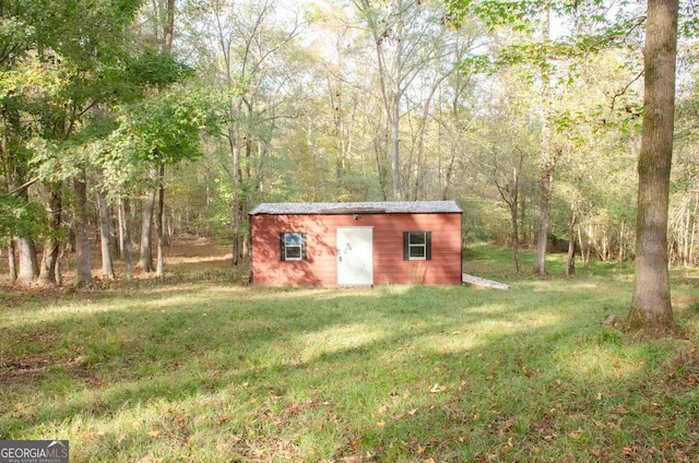 view of outbuilding with a yard