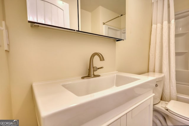 bathroom with shower / bath combination with curtain, vanity, and toilet