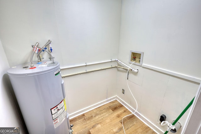 clothes washing area featuring laundry area, hookup for a washing machine, light wood-type flooring, water heater, and electric dryer hookup