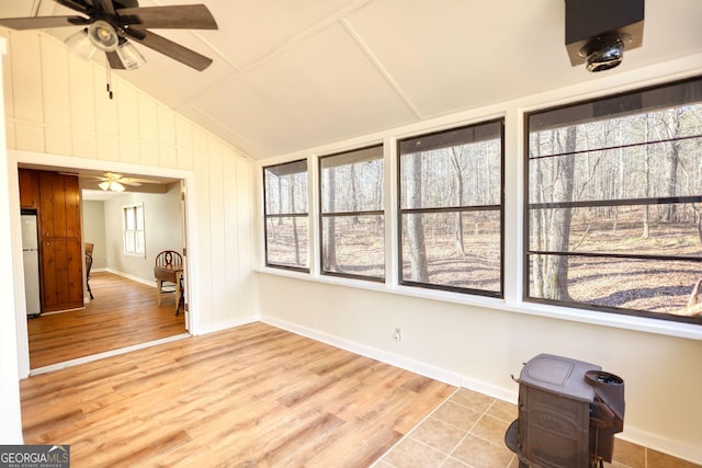 unfurnished sunroom featuring a ceiling fan and vaulted ceiling