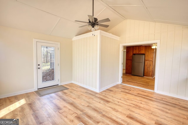 interior space featuring ceiling fan, vaulted ceiling, baseboards, and wood finished floors