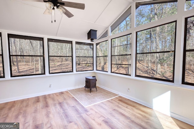 unfurnished sunroom with lofted ceiling and ceiling fan