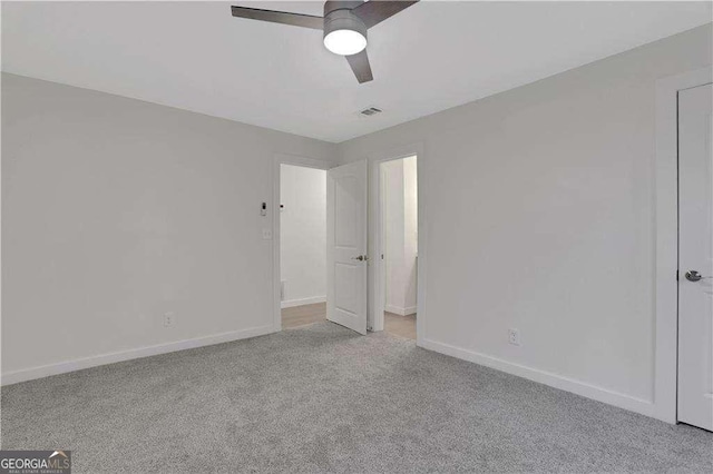 unfurnished bedroom featuring ceiling fan and light carpet