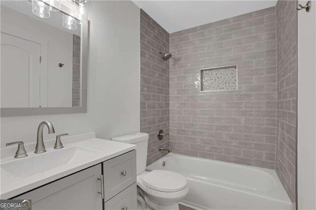 full bathroom with vanity, toilet, and tiled shower / bath combo