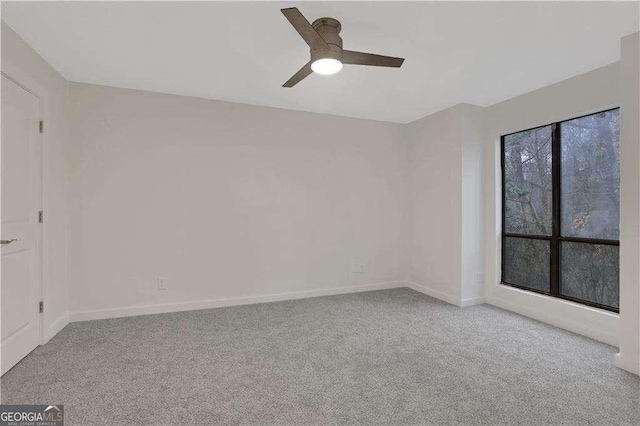 empty room with light colored carpet and ceiling fan