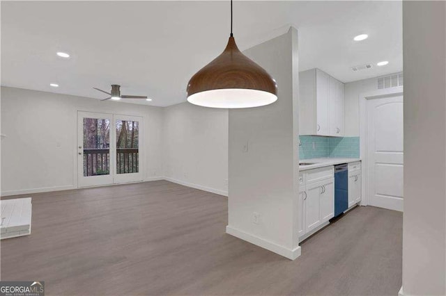 kitchen with white cabinetry, ceiling fan, tasteful backsplash, pendant lighting, and light hardwood / wood-style floors