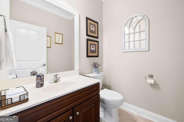 bathroom featuring tile patterned flooring, vanity, toilet, and ornamental molding