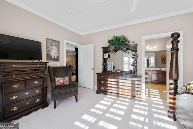 carpeted bedroom with ceiling fan, crown molding, and ensuite bath