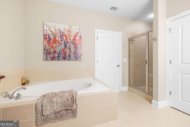 bathroom featuring tile patterned floors, a textured ceiling, and independent shower and bath