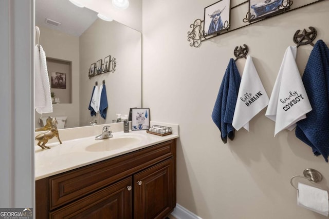 bathroom featuring vanity and toilet