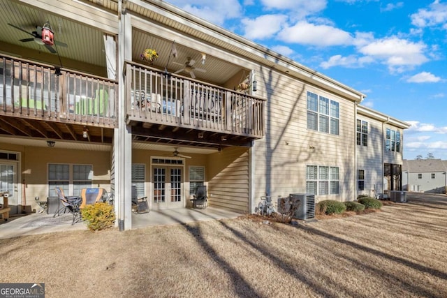 rear view of property with french doors, cooling unit, ceiling fan, and a patio area