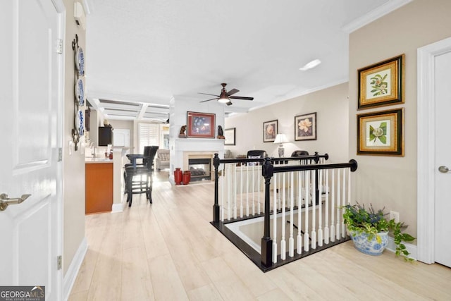 interior space featuring light hardwood / wood-style flooring, crown molding, and coffered ceiling