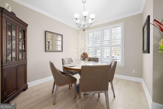 dining space with light hardwood / wood-style flooring, crown molding, and an inviting chandelier