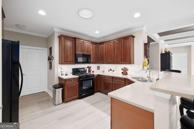 kitchen with kitchen peninsula, decorative backsplash, ornamental molding, black appliances, and light hardwood / wood-style floors