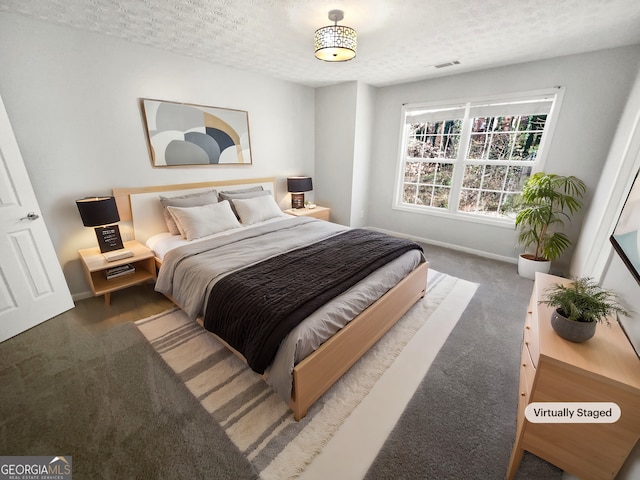 carpeted bedroom featuring a textured ceiling