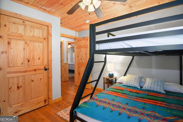 bedroom featuring ceiling fan, light hardwood / wood-style flooring, and wood ceiling