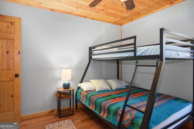 bedroom featuring hardwood / wood-style flooring, ceiling fan, and wood ceiling