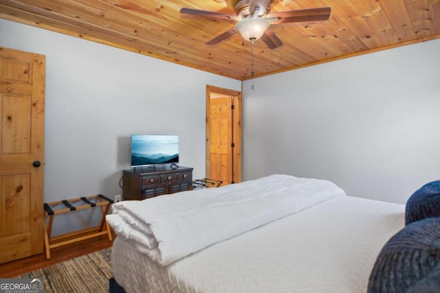 bedroom with ceiling fan, wood-type flooring, wooden ceiling, and crown molding