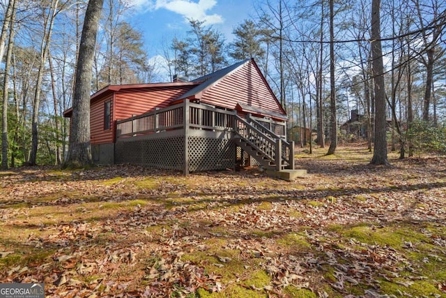 back of house featuring a wooden deck