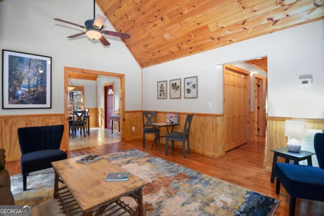 living room featuring hardwood / wood-style flooring, ceiling fan, wood ceiling, and vaulted ceiling