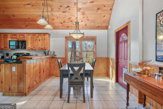 dining area with wood walls, light tile patterned floors, wooden ceiling, and vaulted ceiling